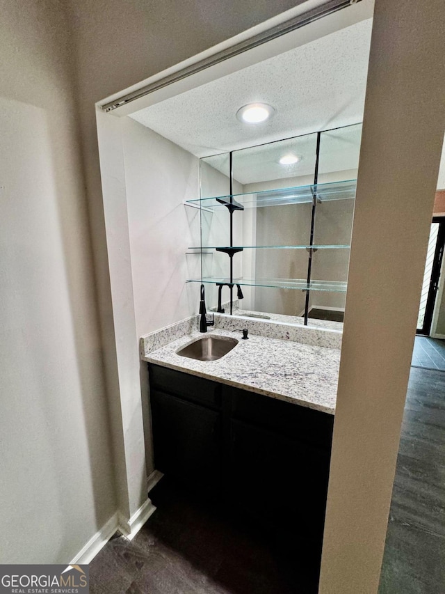 bathroom featuring a textured ceiling and vanity