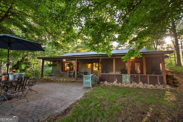 back of house featuring a patio area and a sunroom