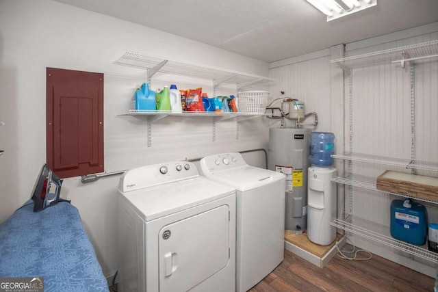 laundry room featuring electric panel, water heater, washer and dryer, and dark wood-type flooring