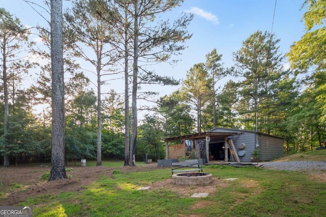 view of yard with an outbuilding and an outdoor fire pit