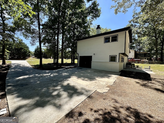 view of side of home featuring a garage