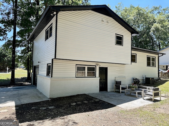 back of house featuring central AC unit and a patio area