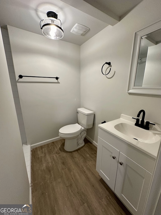 bathroom featuring hardwood / wood-style floors, toilet, and vanity