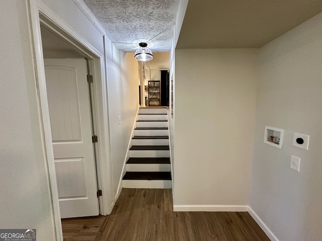 hall featuring a textured ceiling and hardwood / wood-style floors