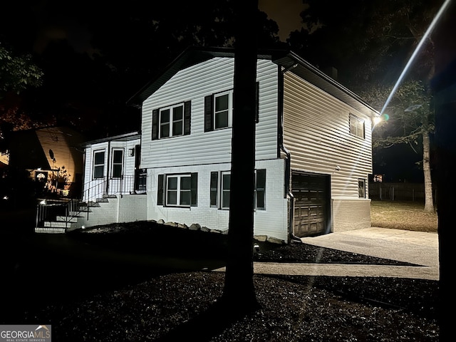 property exterior at twilight featuring a garage