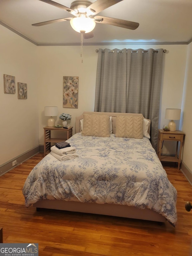 bedroom with hardwood / wood-style floors and ceiling fan