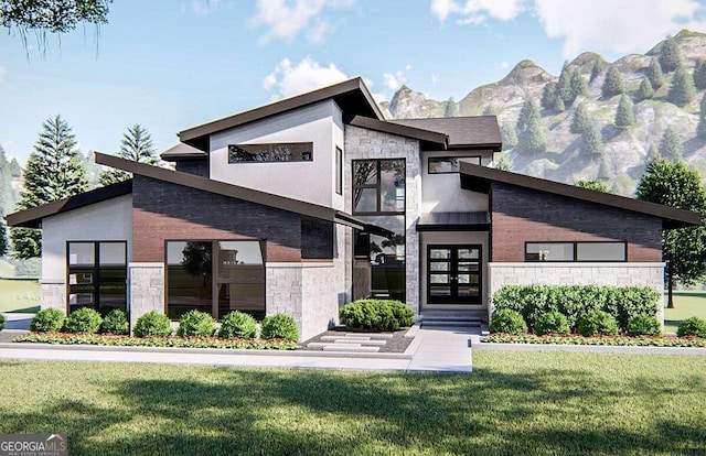 contemporary home featuring a front lawn and a mountain view