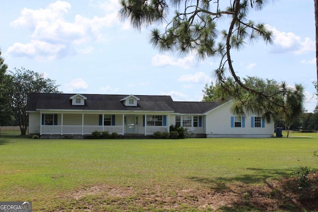 view of front facade with a front yard and covered porch