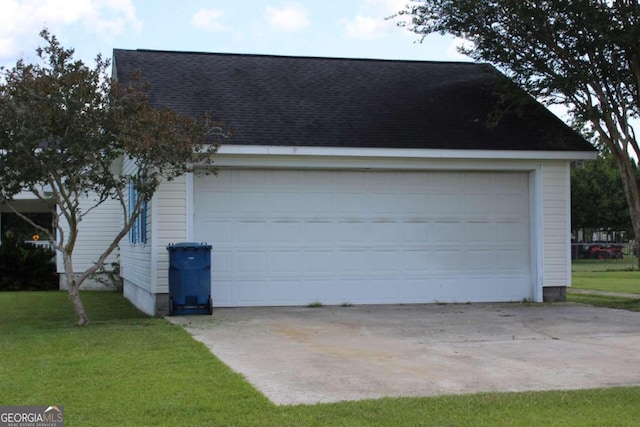 garage featuring a lawn