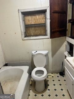 bathroom featuring vanity, toilet, and a bath