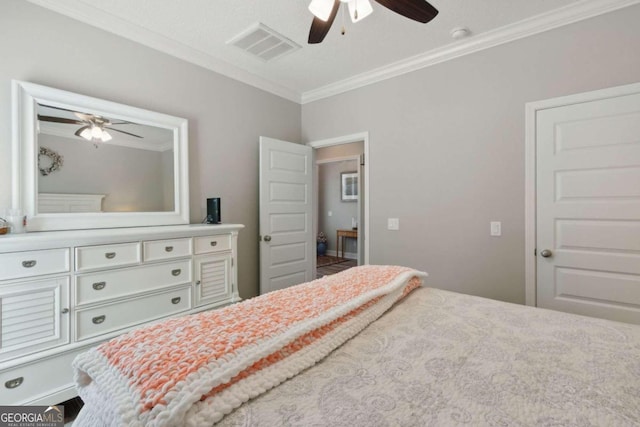 bedroom with ceiling fan and crown molding