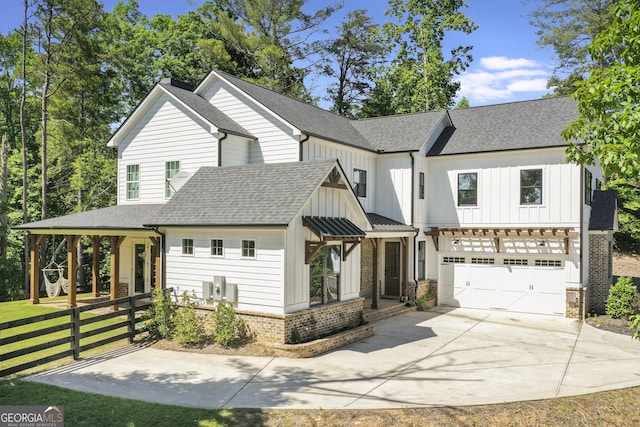 modern inspired farmhouse featuring a garage