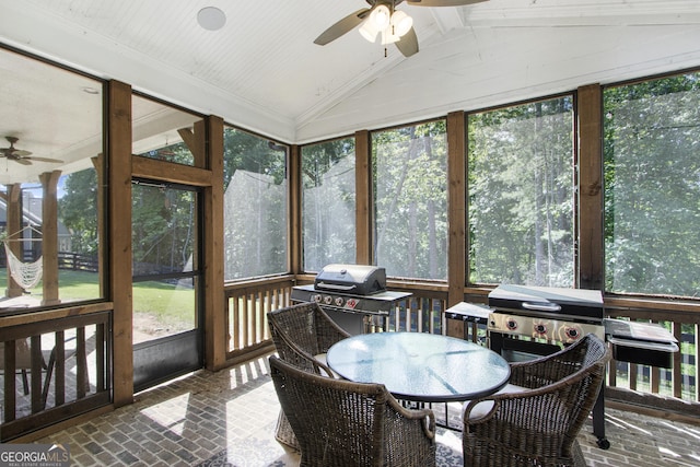 sunroom with a wealth of natural light, lofted ceiling, and ceiling fan