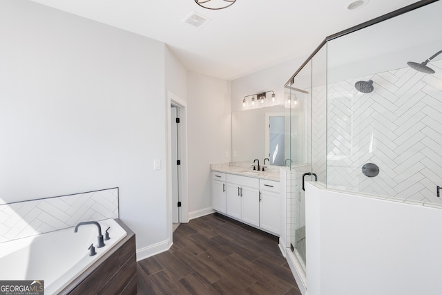 bathroom with plus walk in shower, vanity, and hardwood / wood-style flooring