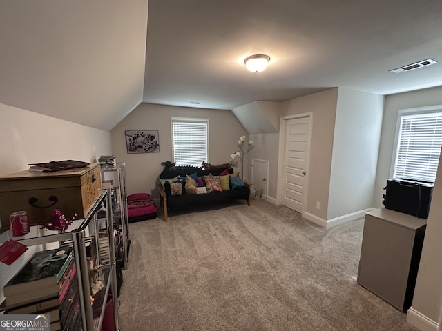 interior space with light colored carpet and vaulted ceiling