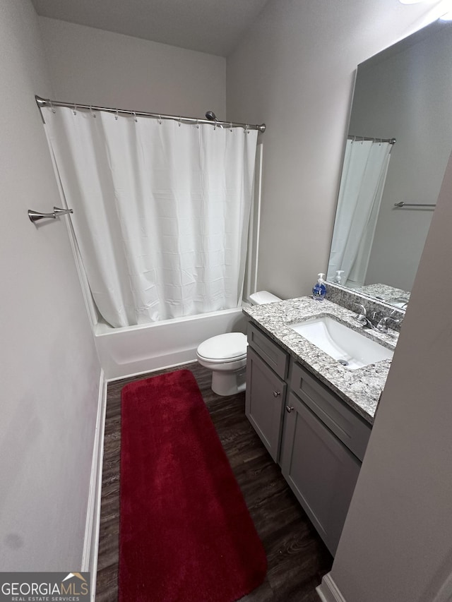 full bathroom featuring vanity, wood-type flooring, shower / tub combo, and toilet