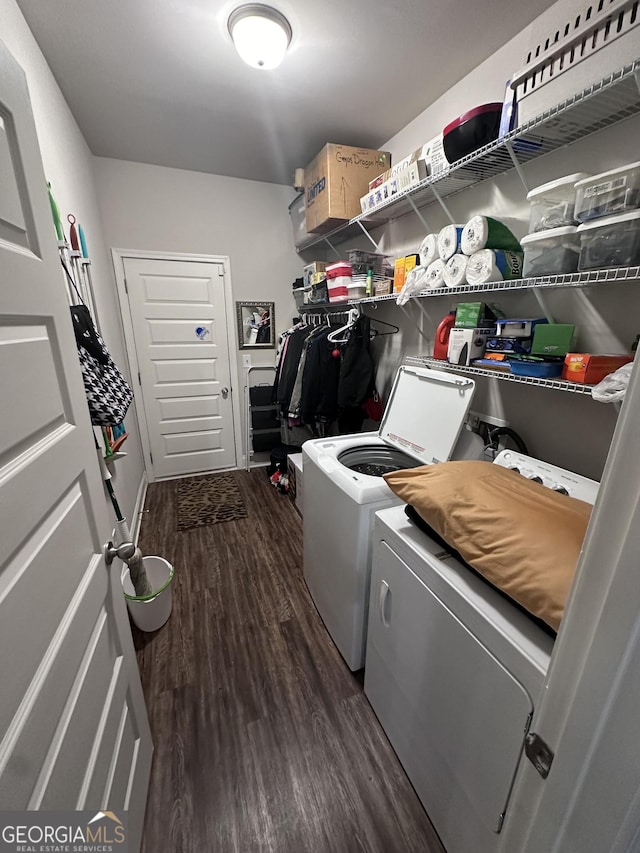 laundry area with washing machine and clothes dryer and dark hardwood / wood-style floors