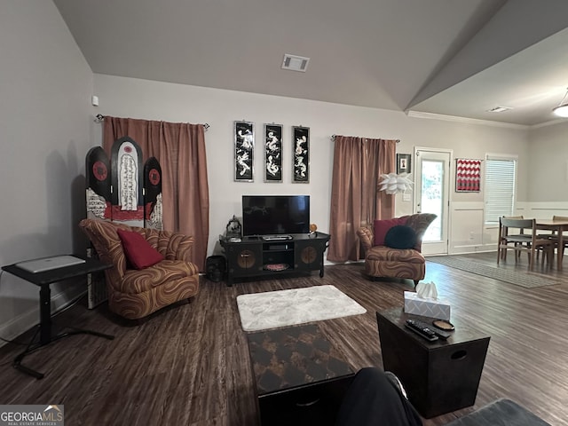 living room featuring hardwood / wood-style floors, ornamental molding, and lofted ceiling