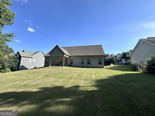 back of house featuring a yard