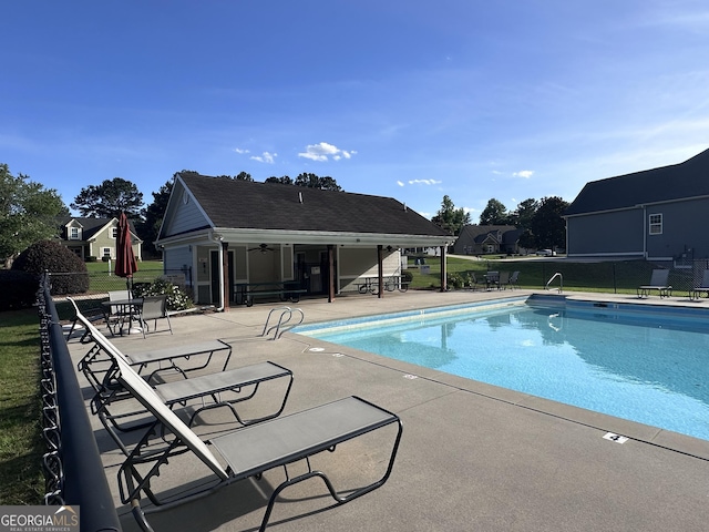 view of pool with a patio and ceiling fan