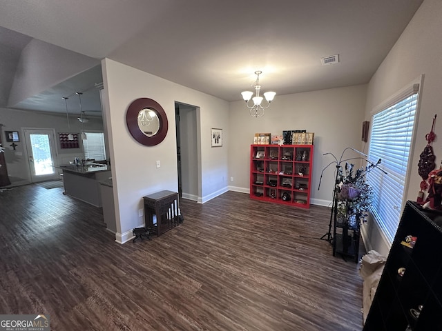 interior space featuring dark wood-type flooring and an inviting chandelier