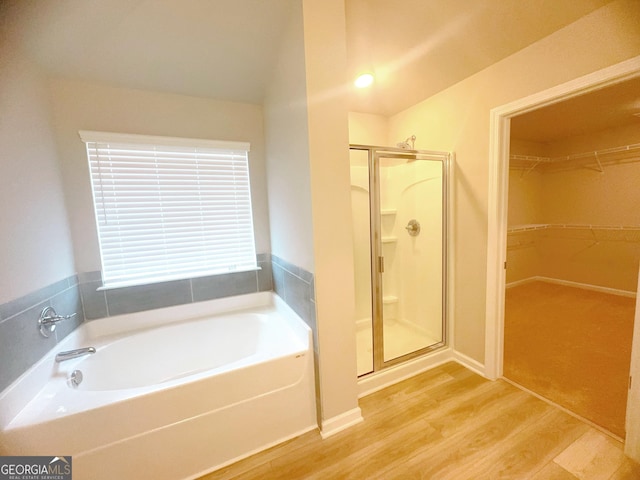 bathroom with separate shower and tub and hardwood / wood-style floors