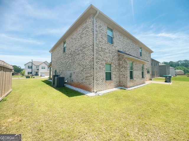 view of side of home with a lawn and cooling unit