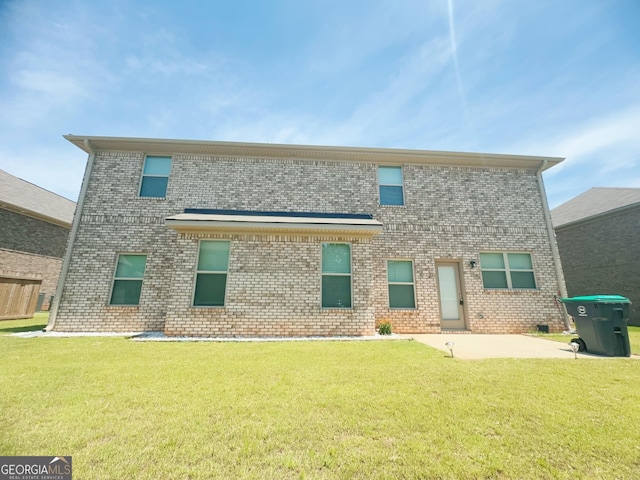 rear view of property with a patio area and a yard