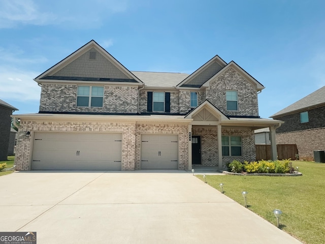 craftsman inspired home featuring a garage and a front lawn