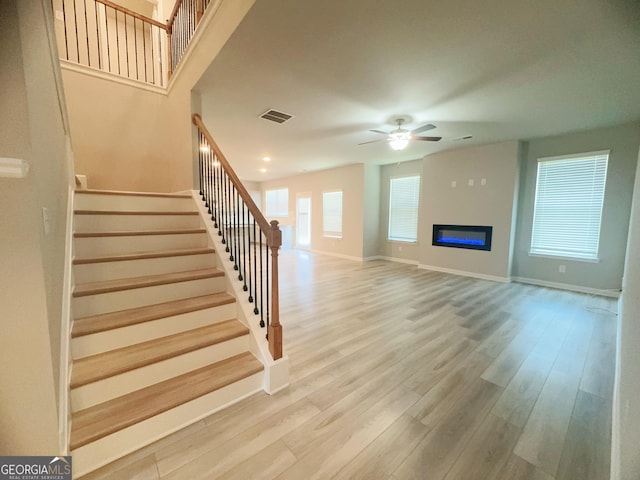 interior space with ceiling fan and wood-type flooring