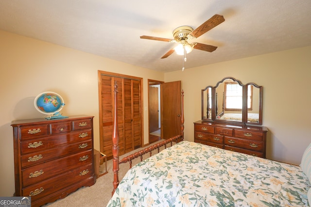 carpeted bedroom featuring ceiling fan and a closet