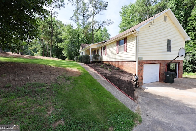 view of side of property featuring a garage and a lawn