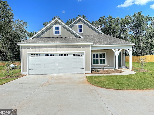 view of front of home featuring a front yard and a garage