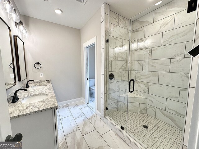 bathroom featuring vanity, toilet, and an enclosed shower