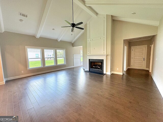 unfurnished living room featuring ceiling fan, dark hardwood / wood-style floors, beam ceiling, and high vaulted ceiling