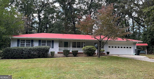 single story home featuring covered porch, a garage, and a front lawn