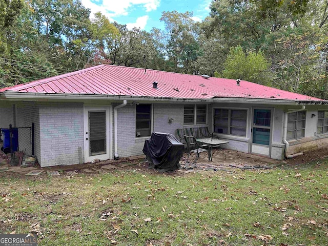 rear view of house with a yard and a patio area