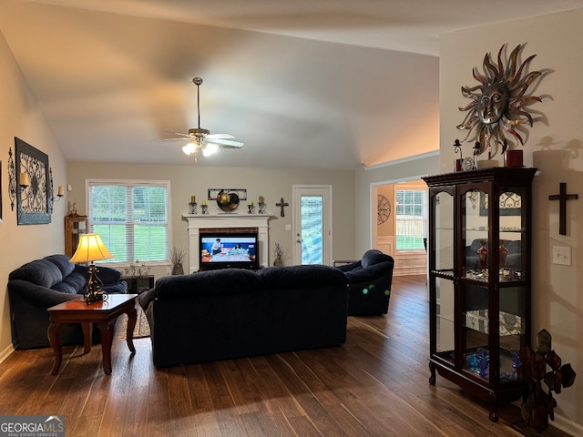 living room with dark hardwood / wood-style floors, ceiling fan, and vaulted ceiling