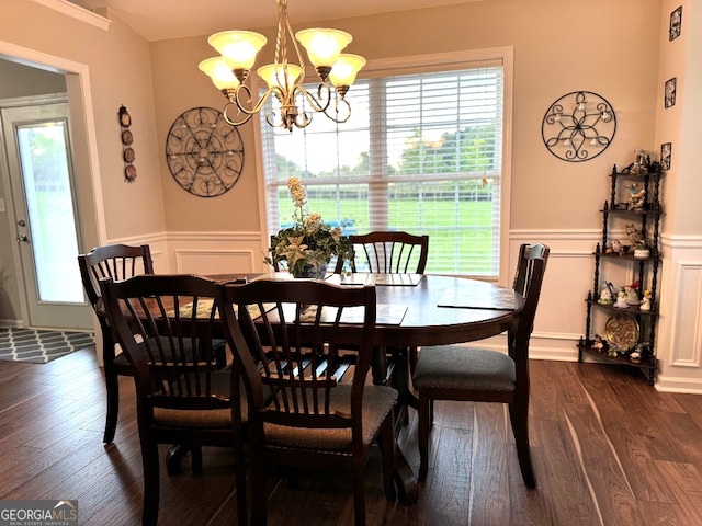 dining area featuring plenty of natural light, dark hardwood / wood-style flooring, and a chandelier