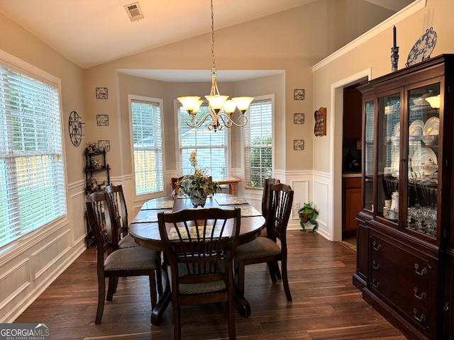 dining space featuring dark hardwood / wood-style floors, a notable chandelier, vaulted ceiling, and a wealth of natural light