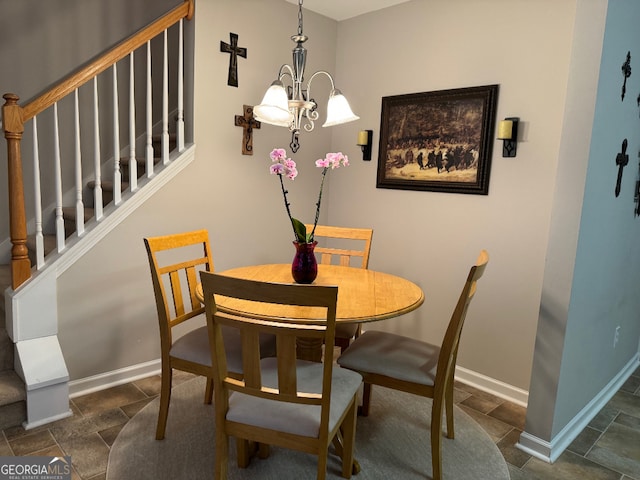 tiled dining area featuring a notable chandelier