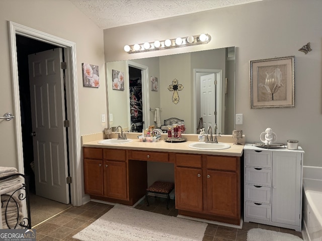 bathroom with a bathtub, tile flooring, and double sink vanity