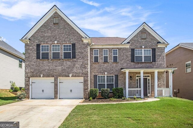 view of front of property featuring a front yard, a porch, central AC, and a garage