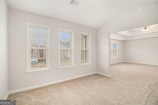 carpeted empty room featuring lofted ceiling and ceiling fan