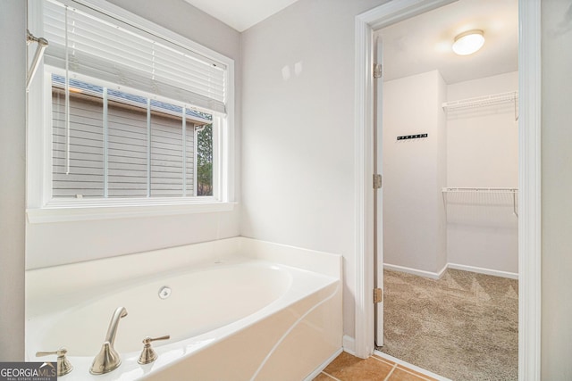 bathroom with a bathing tub and tile patterned flooring