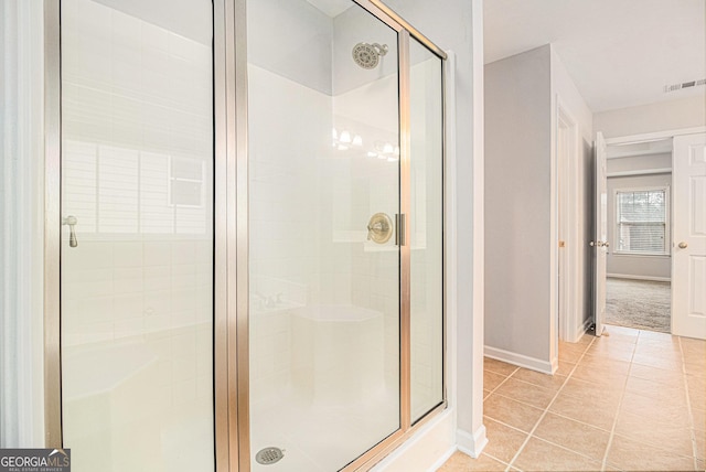 bathroom with tile patterned flooring and an enclosed shower