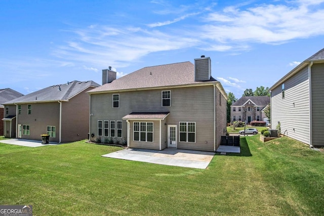 rear view of property featuring a patio area and a lawn