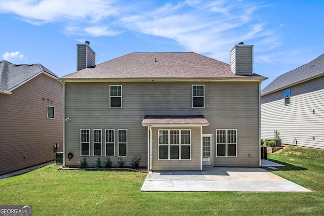 rear view of house with a yard, a patio, and central air condition unit