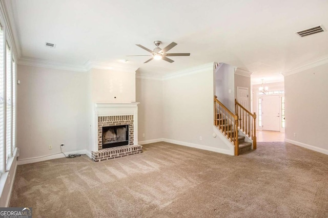 unfurnished living room with plenty of natural light, crown molding, and a fireplace