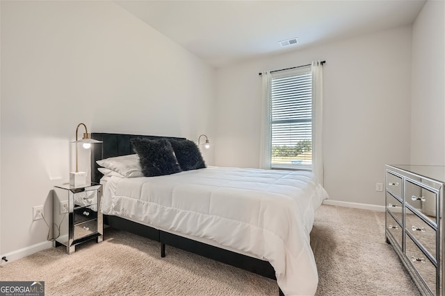 bedroom with carpet floors, visible vents, and baseboards